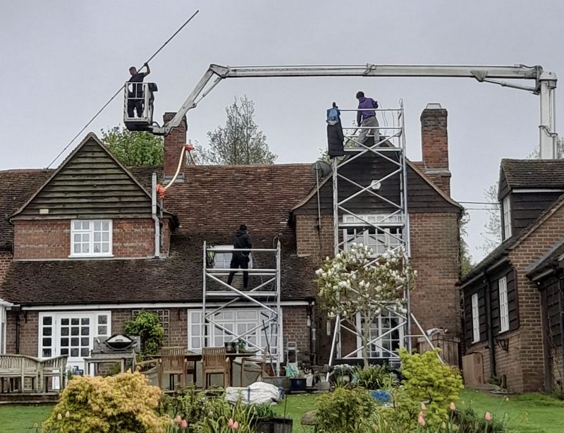 The Roof Moss Cleaners using cherry picker and scaffolding to clean roof safely and professionally in Amesbury, Wiltshire