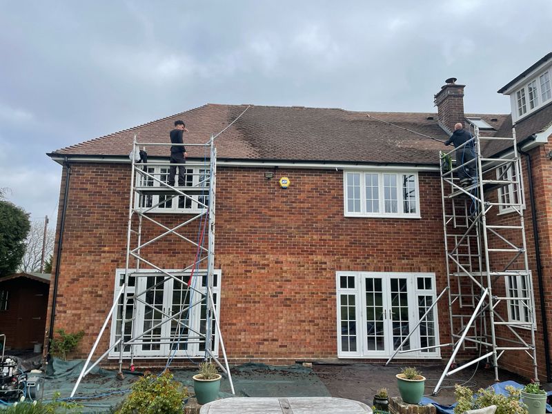 Roof cleaning carried out safely from scaffold towers by The Roof Moss Cleaners in Amesbury